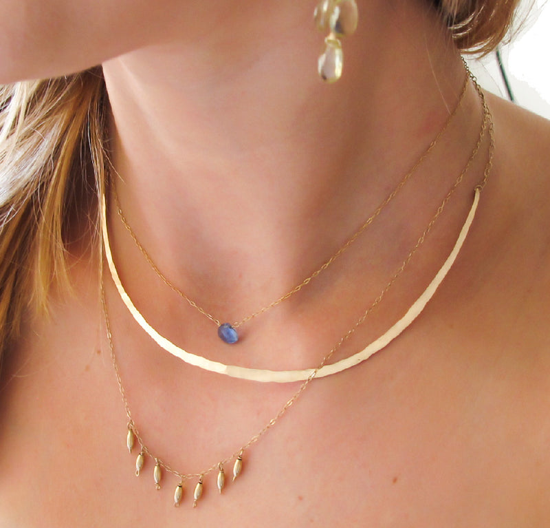 neck closeup of a blond woman wearing a 14k gold filled crescent collar necklace 