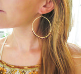 wire wrapped garnet and 14k gold filled large hammered gold hoop earrings by delia langan jewelry