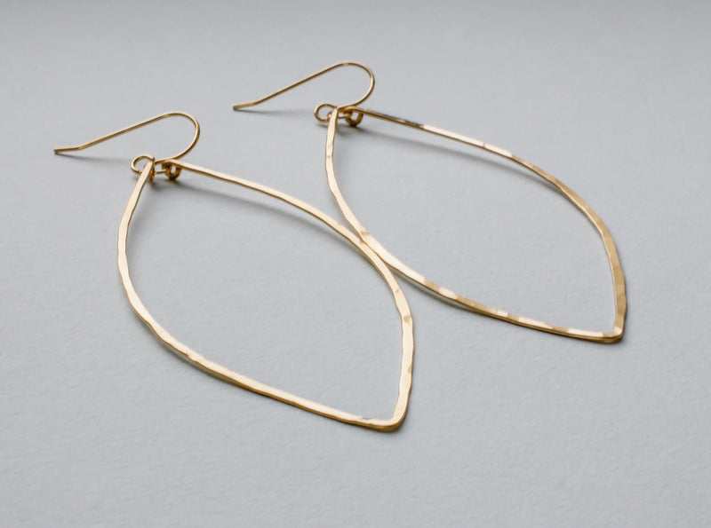 14k gold filled xl leaf hoop earrings on grey surface 