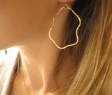 blond woman ear closeup wearing 14k gold filled yung spud hoop earrings